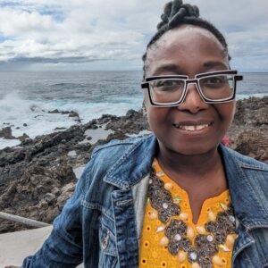 Woman smiling in front of beach